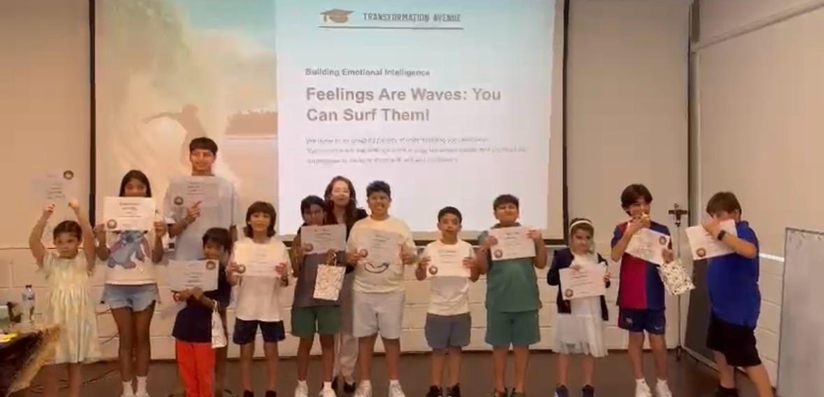 Children holding certificates at a Transformation Avenue emotional intelligence workshop in Dubai